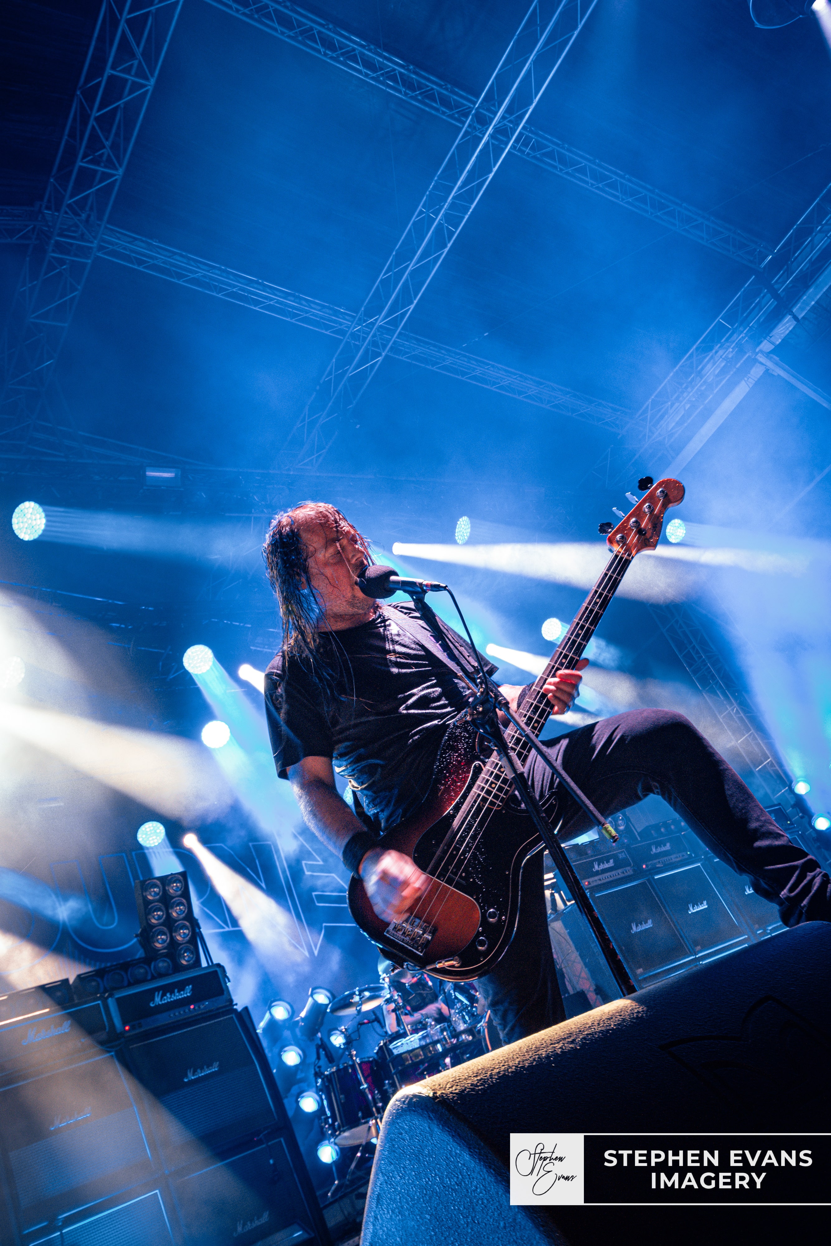 Airbourne bass guitarist Justin Street performing live on stage