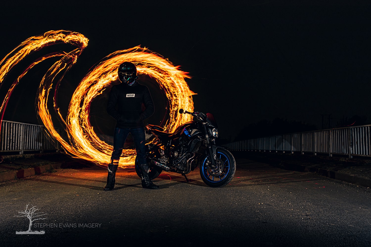 Motorcycle photoshoot featuring fire effects and slow shutter speed