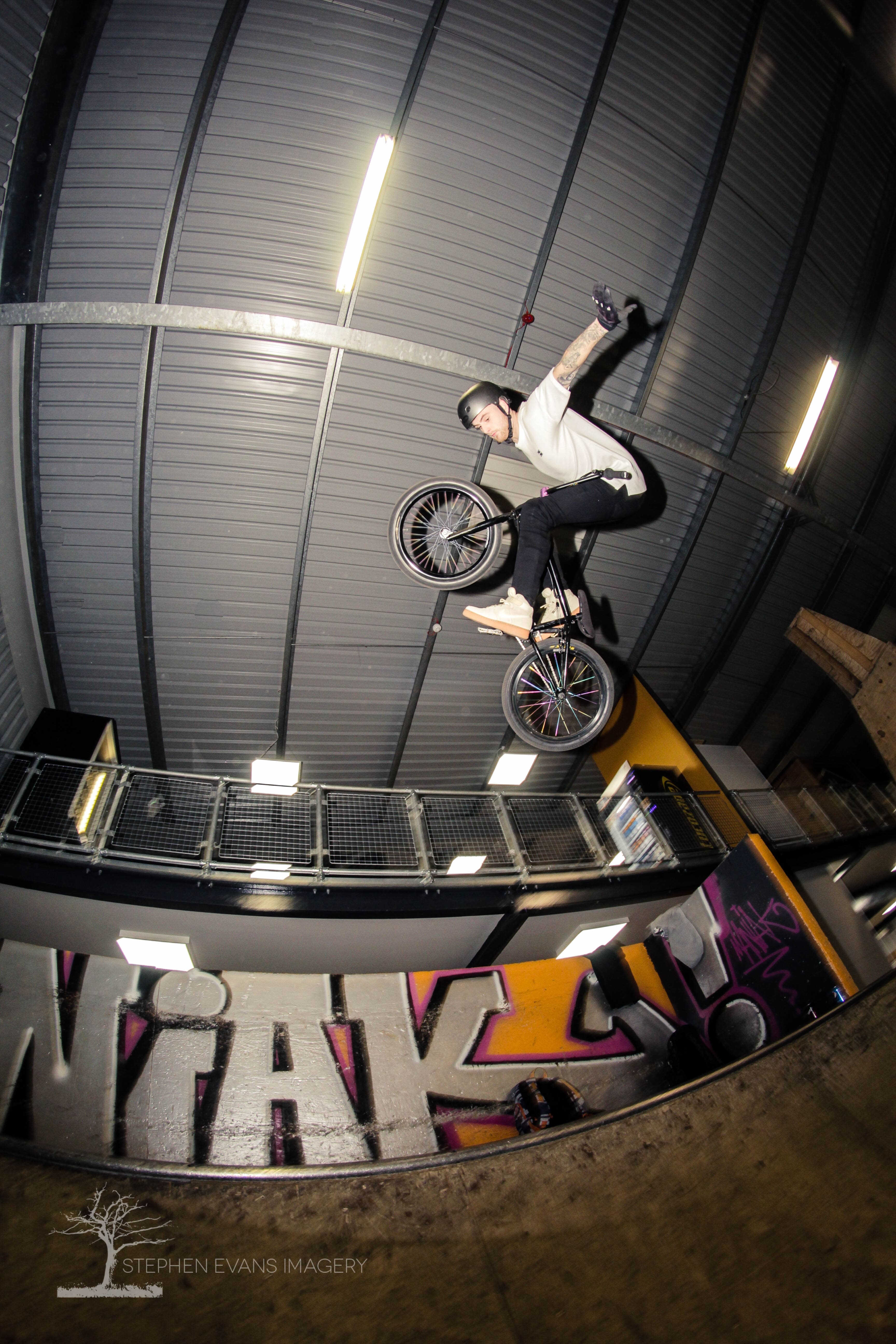 BMX rider Jack performing no-hander trick on halfpipe ramp