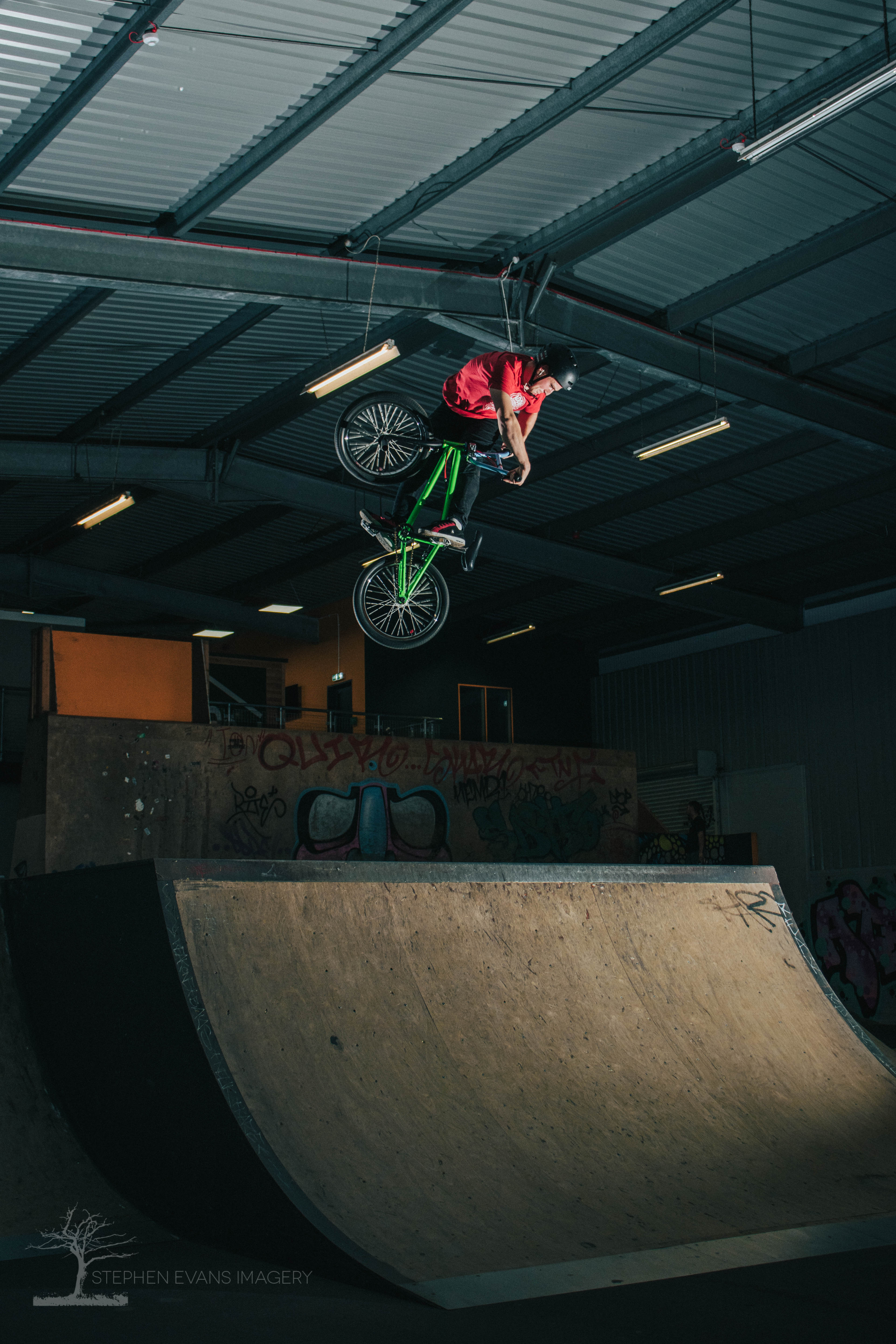 BMX rider Josh Bates executing 360 turndown trick over box at KASET Skatepark